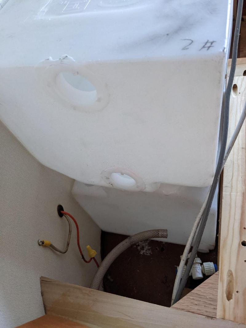 Tucked into the curve of the shell, plumbing roughed in.