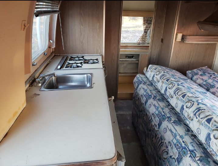 The interior as found: the original galley and a lot of brittle 1970s plastic.