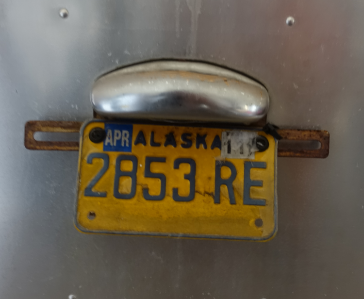 An older Alaska tag under the expired Missouri plate.